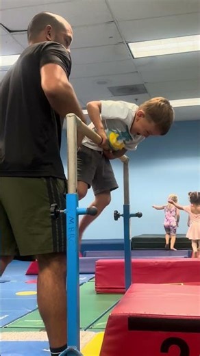 Kids gymnastics class backflips over the bar