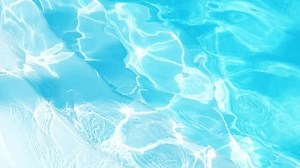 Clear shiny water in a blue pool. Concept of vacation and tranquility.