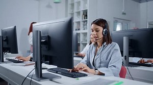 clip-3500413985-young-brunette-woman-talking-by-headset-clients