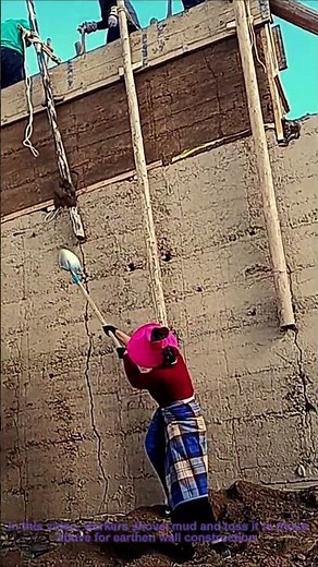 Traditional Wall Building: Workers Shovel and Toss Mud for Earthen Wall Construction