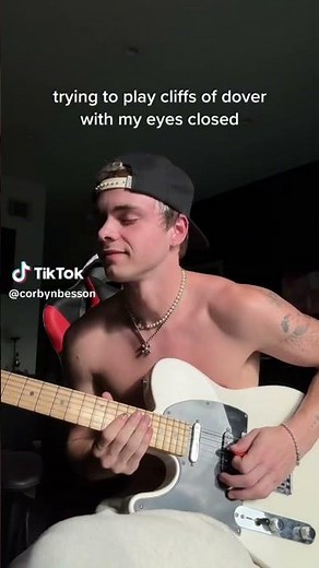 Corbyn Besson trying tk play guitar with his eyes closed