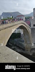MOSTAR, BOSNIA AND HERZEGOVINA - SEPTEMBER 10, 2025: Crowd of people crossing the Stari Most, a UNESCO World Heritage site. Concept of historic tourism and iconic Balkan architecture Stock Video Footage - Alamy