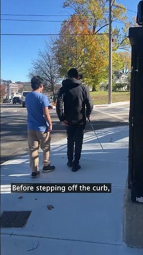 Blind students learn how to safely cross a street
