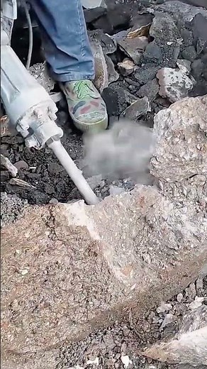 Breaking old concrete surface using electric demolition hammer tool