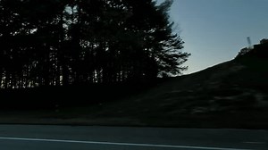 Pov side point of view of driving in car vehicle road trip with forest at sunset time