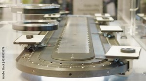 Automatic test set scanning details on high speed laboratory conveyor belt. Computer-aided quality system with scanner controlling properties of items on transporter. Scanning unit automatic testing