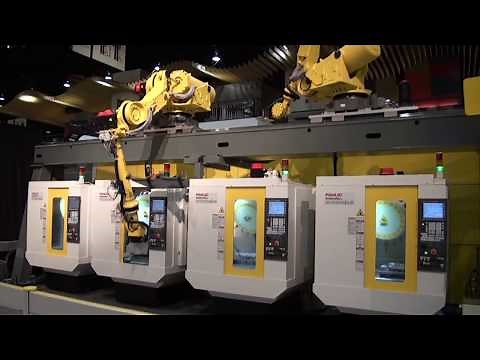 Two Overhead Robots Load Unload Four FANUC ROBODRILL Machine Tools FANUC Robotics