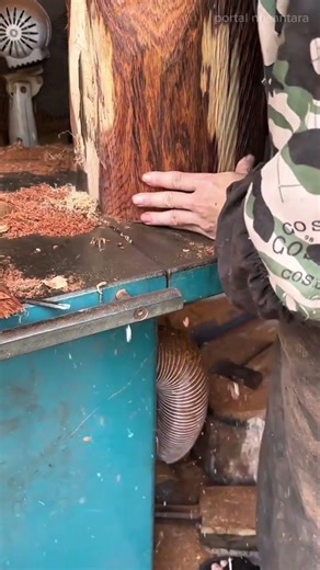 Cutting a thick piece of wood with a bandsaw and removing the excess scraps from the working table