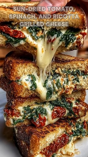 Bread buttered thick. Sprinkle parmesan, provolone, basil. Grill on medium-low for 4–6 minutes. This grilled cheese turns melty, garlicky, and packed with sweet sun-dried tomato flavor. Ingredients ➤ 2 oz shredded provolone ➤ 1/3 cup ricotta ➤ 3 tbsp shredded Parmesan ➤ 1 small garlic clove, minced ➤ Salt & black pepper ➤ 3 cups fresh spinach ➤ 4 slices bread ➤ 2 tbsp chopped basil ➤ 3 tbsp minced sun-dried tomatoes FULLL Recipe in First Cօʍʍеոτ 👇👇 | Nessy Recipes