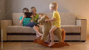 appy calm children are playing with tablet. boys are happy together on vacation at their parents' house. Friendly joint preparation for school