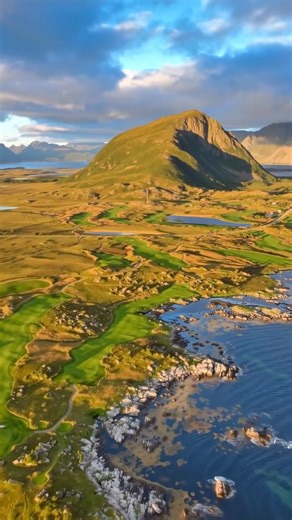 VUZE GOLF on Instagram: "⛰️ Lofoten Links 👇 🌄 Set on a remote Arctic peninsula where mountains meet the sea — play beneath the midnight sun or the northern lights on one of the world’s most dramatic courses 📍 Gimsøya, Lofoten Islands, Norway 🏡 Stay in on-site cabins overlooking the ocean for a true northern golf experience 📸 - @garylisbongolf / Brought to life using AI 🏌️ Send this to your travel buddy #beautifulgolf #luxurygolf #norwaygolf"