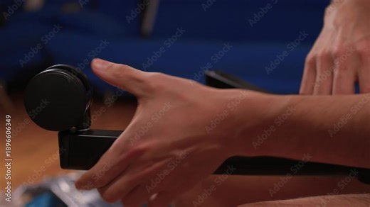 Hands assemble chair. Calm living room scene showing detailed furniture assembly process. Detailed tutorial on attaching casters and parts to chair base with precise technique