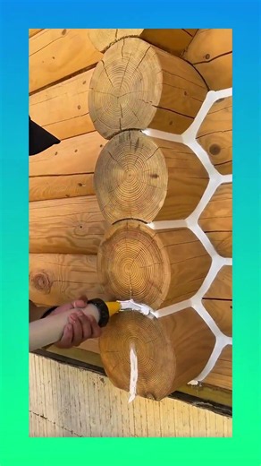 The satisfying process of applying white sealant chinking to log cabin walls! #logcabin #woodworking