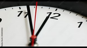 Clock face 4K UHD real time footage at 12 noon or 12 AM. Red second pointer clicks. Clock time ticking on a classic Wall Clock. Shadows moving over the Watch. Half of a Clock dial close-up isolated.