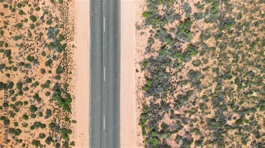 Aerial view of the road to Exmouth, Western Australia, surrounded by termite hills and arid landscape