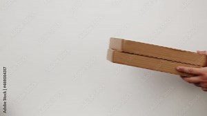 Square cardboard boxes on white background. Preparing take away meals. Online contactless food shopping. Food delivery service. Courier taking order, delivering to customer.