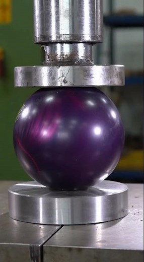 Bowling ball crushed under extreme pressure. Realistic hydraulic explosion test.