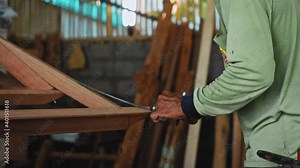 hands of the master measuring the size of the tree in the workshop with a ruler for subsequent sawing
