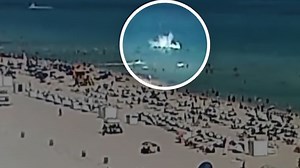 Video captures helicopter crashing into ocean near packed Florida beach