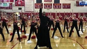 Dancing priest wows students at pep rally