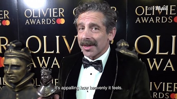 Elliot Levey and Romola Garai react after winning Olivier Awards
