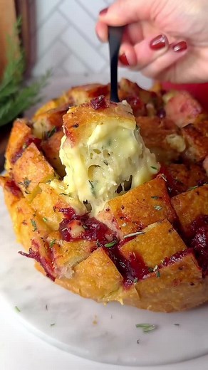 Delish on Instagram: "The one appetizer that everyone will be reaching for this Christmas 🙌 Grab the recipe for our Cranberry Brie Pull-Apart Bread at the link in bio. 🎥 @thegarnishedpalate @itsashrev"