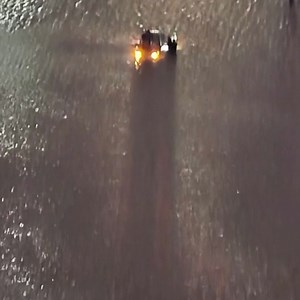 Another great rescue by our Marine Unit and the Washington National Guard On Monday night, at 277th & 68th in South King County, a driver got stuck and had to climb on top of his car. That's a National Guard Tall Transport vehicle with the assist. | King County Sheriff's Office