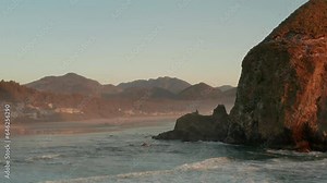 Aerial shot past haystack rock towards cannon beach