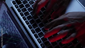 Extra close up of hacker fingers typing on laptop keyboard. Hands coding web script on computer screen. Male hacking computer and password. Man developer programming on laptop. Slow motion