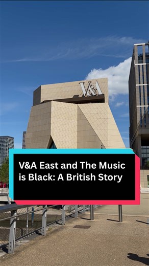I walked into V&A East expecting the usual museum script, quiet rooms, soft footsteps, culture behaving itself. Instead? 125 years of sound, migration, resistance, and basslines hitting like a body check. This new East London gallery doesn’t curate history, it broadcasts it. At the centre is The Music is Black: A British Story, an exhibition that drags you through the long shadow of empire into the pulse of modern Britain. Gospel. Calypso. Windrush. Then ska and 2 Tone, The Specials, Madness, be