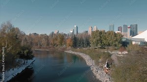 Aerial: Flying over the Elbow river for an establishing shot of the Calgary city skyline. Calgary, Alberta, Canada. Stock Video