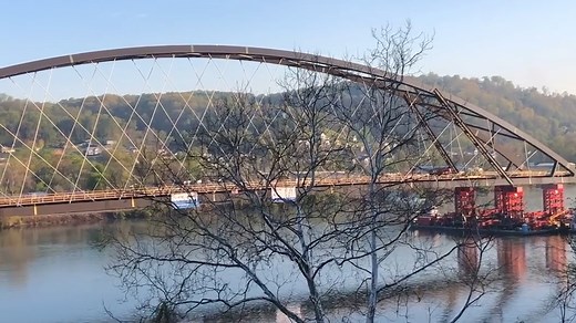 Fully completed suspension bridge floated down the Ohio River en route to it’s new home