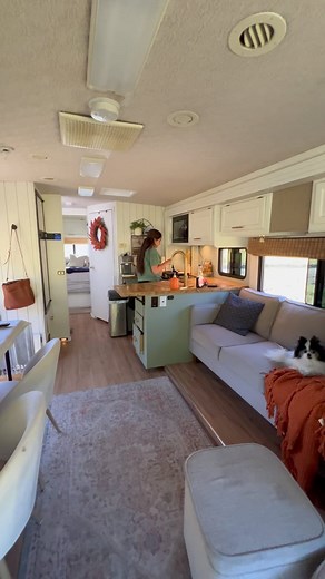 A hidden dishwasher, popup TV and the cutest little stove. You don't see that in many RVs! See the listing for this beautiful RV renovation at White Home On Wheels #rvforsale #renovatedrv #lovethatrv #rvrenovation #rvinspiration | Love That RV