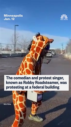 The comedian and protest singer known as Robby Roadsteamer was protesting in a giraffe costume when he was arrested by ICE in Minneapolis. | NBC News