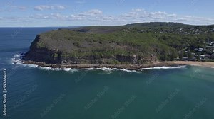 MacMasters Beach Rock Pool - Serene Oceanic Enclave Between Rugged Headland And Pristine Sands In MacMasters Beach, NSW, Australia. aerial sideways