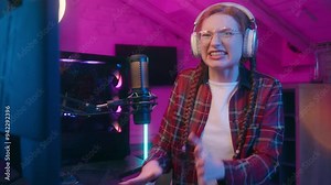 Stressed worried Caucasian girl woman teenager streamer gamer play online game computer gaming addiction female blogger influencer player in headphones watch video cyber stream e-sport fail upset home