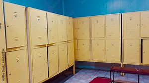 Changing room interior with closed and open lockers in swimming pool or gym