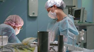 Close-up of surgeon. Doctors and assistants working in the operating room. Surgical team and honey nurse during a real operation in a modern operating room, 4k