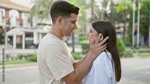 Affectionate man touching woman's face tenderly on a sunny urban street