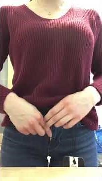 Buttoning and unbuttoning tight blue jeans