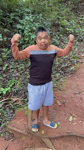 Child puts finger in jaguar's mouth.