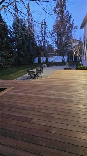 This IPE Decking looks incredible in every light, rich in the night - and the durability speaks for itself. For this project, we built the deck around an existing tree to keep the natural layout of the yard. 🌳 The homeowners loved that we could adapt the design instead of forcing the space to change. ⭐️ Safety always comes first. A sleek railing around the window well to keep everything secure without taking away from the look. If you didn’t know we offered IPE... now you do. It might be the pe