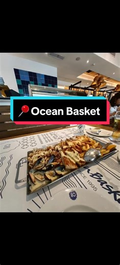 Ocean Basket served seafood platter. I prefer the platter for two as it includes hake, flour, prawns, spice mate, mussels, lemon garlic sauce, calamari, fish spice, creamy lemon sauce, chips, rice, oil, and lemon. It's a great combination for a complete meal. We also received some complimentary bread and butter as a starter. We chose salmon sushi and cocktails. I only enjoy dining at La Croisette outlets. The service there is more professional, quicker, and more attentive to detail compared to t