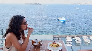Male, Maldives - 10th may, 2024: tourist eat tasty maldives meals.Italian style spaghetti pasta meal with various herbs and tomatoes and grilled shrimp. Maldives cuisine concept