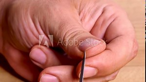 close-up a man manicuring his nails with a manicure tool. 4k video capture