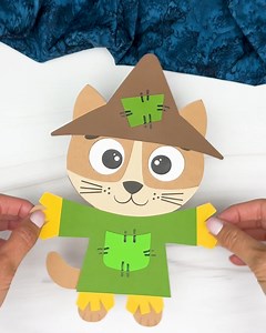 Scarecrow Cat Craft - cute fall idea for kids! Get the template here: https://www.simpleeverydaymom.com/scarecrow-cat-craft/ Follow us Simple Everyday Mom for more craft ideas. #kidscrafts #craftsforkids #fallcraftsforkids #kidsactivities #simpleeverydaymom #ideasforkids | Simple Everyday Mom