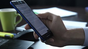 Reading News with Telephone | Premium Stock Video Footage