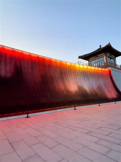 No grand scenes today—let's follow a water droplet's perspective on an immersive journey. My lens starts at the source of a water ornament—a hidden copper spout—watching the water birth and slip down like silk. It flows over moss-covered rocks, creating tiny splashes and foam; merges into a narrow stream, speeding up; meets a drop, forming a small waterfall; then slows down in an open shallow pond, swaying leisurely, finally cycling back to the start via underground pipes. The entire process is 