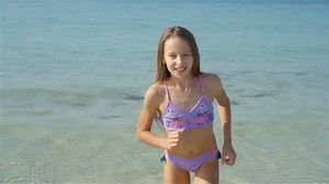 Cute little girl at beach during summer vacation