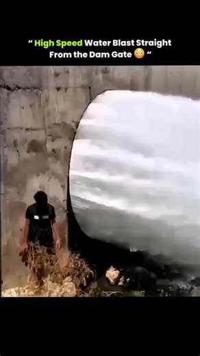 sci || teach || physics || on Instagram: "A dam sluice gate releases high-pressure water at full force, creating a powerful sheet-like outflow. . . . The person standing nearby highlights the immense speed and volume of water, which can be extremely dangerous due to its force and current. . . . Such gates are opened to regulate reservoir levels, manage flood control, or supply water to irrigation canals and turbines in hydroelectric systems. . . . Standing close to an open sluice gate is highly 